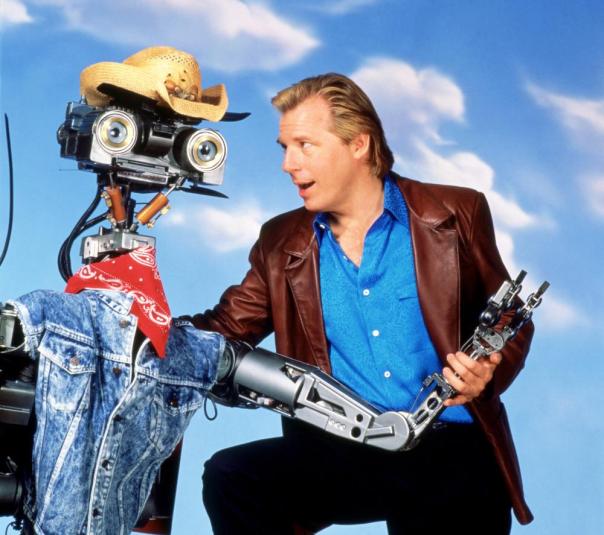 SHORT CIRCUIT 2, from left: Johnny Five, Michael McKean, 1988, ©TriStar Pictures